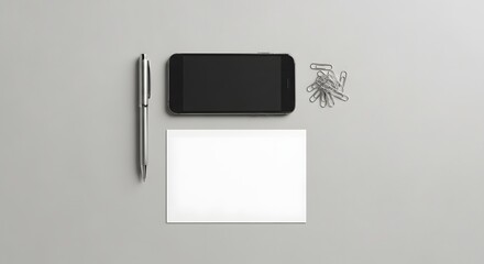 Minimalist workspace with a smartphone, pen, paper, and paper clips arranged on a light gray surface for productivity and organization