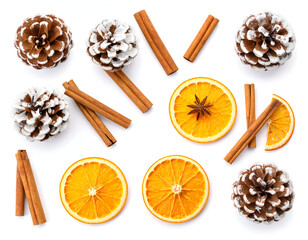 Snow-dusted pinecones, dried oranges, and cinnamon sticks for natural decoration on white