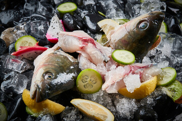Arrange the glistening, white slices of fresh fish on a black round porcelain plate.