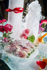 Arrange the glistening, white slices of fresh fish on a black round porcelain plate.