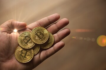 Close up cryptocurrency coins on hand