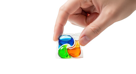 Hand holding colorful laundry detergent capsules against