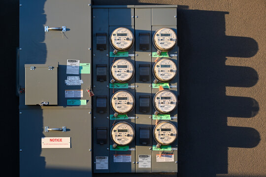 Top-down view of a multi-unit electric SRP meter bank mounted on a wall, showing utility monitoring infrastructure for a multifamily residential building