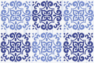 Ikat seamless pattern with blue abstract floral ornament. Vector geometric background for traditional fabrics and carpet design. Retro rug decorative illustration