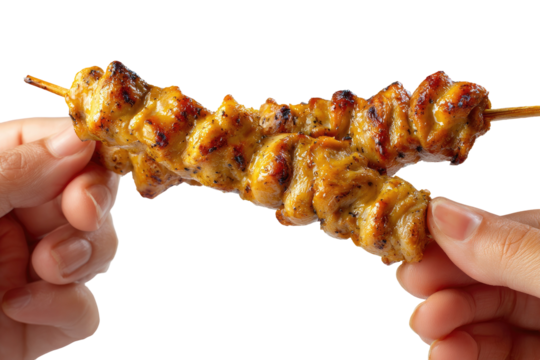 Two hands hold a grilled, golden-brown skewer of savory chicken, ready to eat