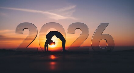 New year 2026 concept with a woman's silhouette in a yoga pose at sunset. Health, wellness, and fitness goals for the future
