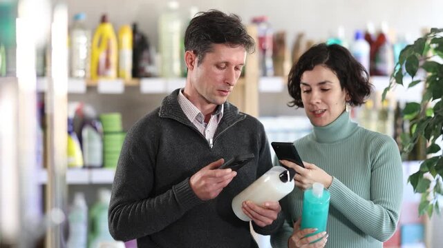 Man uses barcode to get information about shower gel in mobile application. Store visitors scans QR code and follows link to product page in marketplace. 