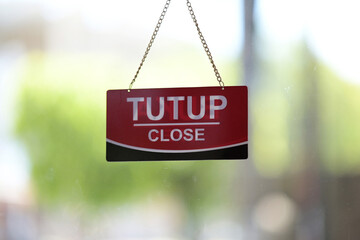 Business closed sign on glass door, seasonal business