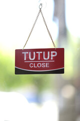 Business closed sign on glass door, seasonal business