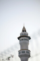 Majestic mosque minaret against clear blue sky