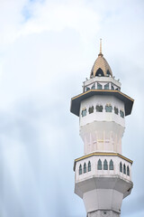 Majestic mosque minaret against clear blue sky