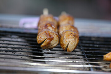 Juicy meatballs grilling on a smoky barbecue grate
