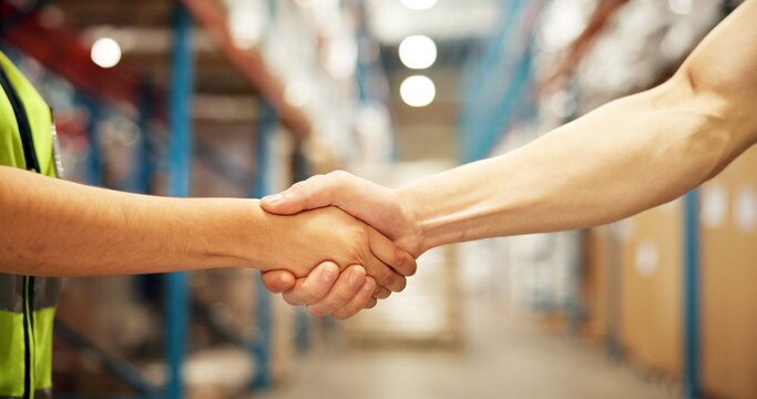 Business people, logistics or handshake with deal in warehouse for partnership, b2b or supply chain. Closeup, distributor or supplier shaking hands in aisle for shipping, distribution or wholesale