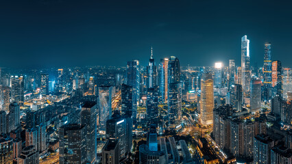 Aerial view of the glowing skyscrapers and modern architecture in the financial district of a major city at night in Guangzhou.
