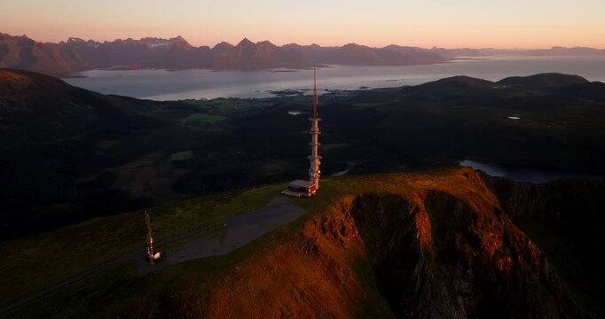 Aerial drone view of TV and radio tower on Storheia mountain at sunset, Stokmarknes, Norway