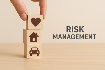 Risk management illustration using layered wood cubes featuring heart, home, and car symbols. This visual emphasizes importance of managing personal and property risks effectively