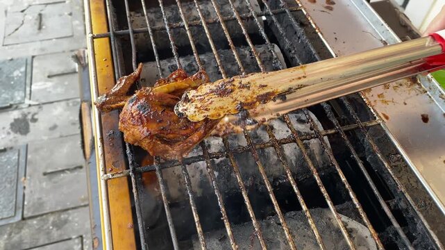 Juicy chicken leg sizzling on smoky bbq grill