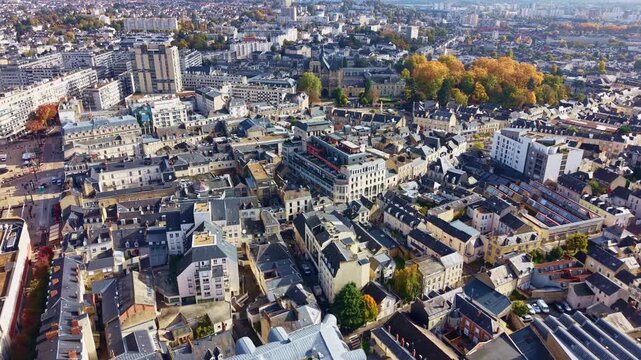 Drone advancing shot over Le Mans city center, showing the Pr&eacute;fecture de la Sarthe and surrounding urban architecture on a sunny autumn day.
