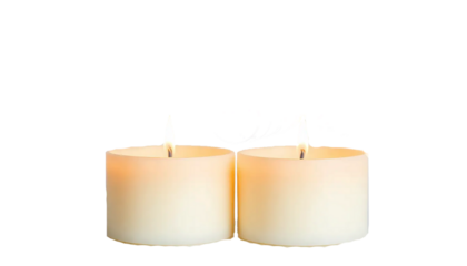 two scented candles with soft flames, placed side by side, warm cozy glow, luxury spa mood, isolated on transparent background.