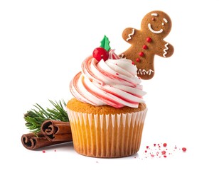 Festive cupcake with swirled frosting, a gingerbread man, and Christmas decorations, set against a clean white backdrop