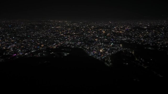 Aerial night footage of Kathmandu city during Diwali (Tihar), featuring the illuminated Dharahara Tower and glowing skyline filled with festive lights, showing Nepal&rsquo;s vibrant cultural celebration.
