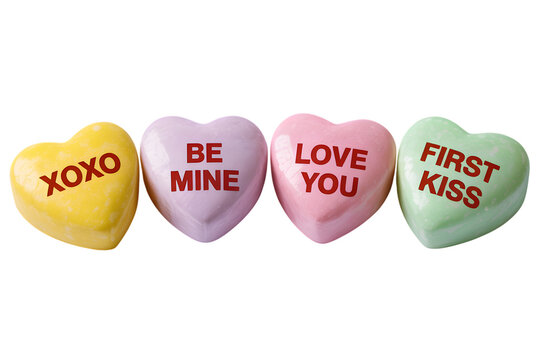 Four colorful heartshaped candy conversation hearts with messages