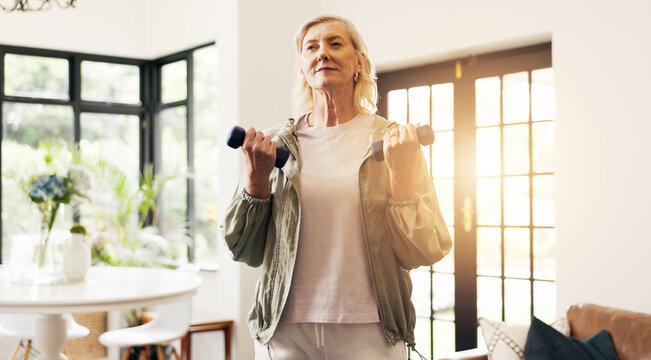 Senior woman, fitness and dumbbells in home with weightlifting, strength training and routine. Elderly person, exercise and strong with muscle development, workout and flare in retirement at house