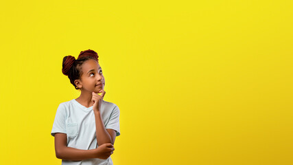 A girl stands with a thoughtful expression, left hand on her chin, looking upwards. She wears a simple light shirt and has distinctive braided hair, set against a vivid yellow background.