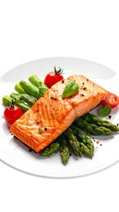 Grilled salmon fillet with asparagus, tomatoes, and basil on a white plate