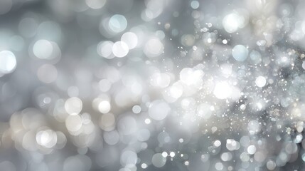 a shimmering abstract background featuring soft glowing white and silver bokeh lights creating a dreamy and festive atmosphere