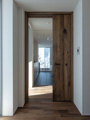 wooden door leads to bright hallway with large windows, modern architecture and natural light. warm tones of wood contrast with sleek design, creating welcoming space