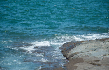 Blue-Green Ocean Waves Hitting Rocky Shore
