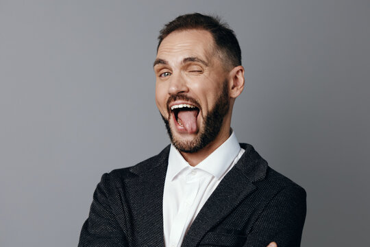 Professional man in business attire stands against a neutral color background, conveying strong emotion, confidence, and approachability for a modern corporate concept and branding.