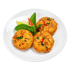 Thai tod man pla fish cakes with kaffir lime leaves, perfectly isolated on a pure white background