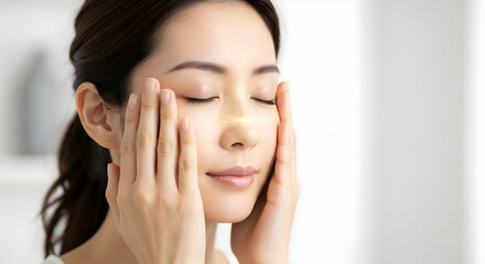 Beautiful Asian Woman Applying Facial Treatment with Golden Glow Effect