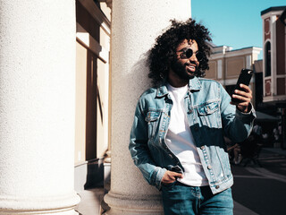 Handsome smiling hipster  model.Sexy unshaven Arabian man dressed in summer jeans jacket clothes....