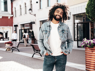Handsome smiling hipster  model.Sexy unshaven Arabian man dressed in summer jeans jacket clothes....