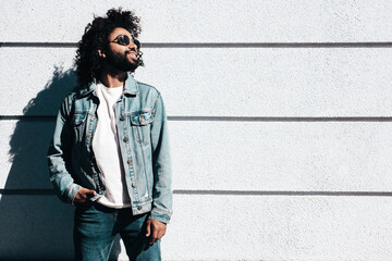 Handsome smiling hipster  model.Sexy unshaven Arabian man dressed in summer jeans jacket clothes....