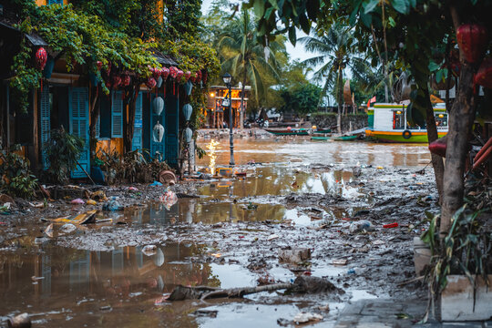 flooded city or town with buildings submerged in overflow water and mud, village underwater after heavy tropical rain and typhoon, consequences with dirt on the street