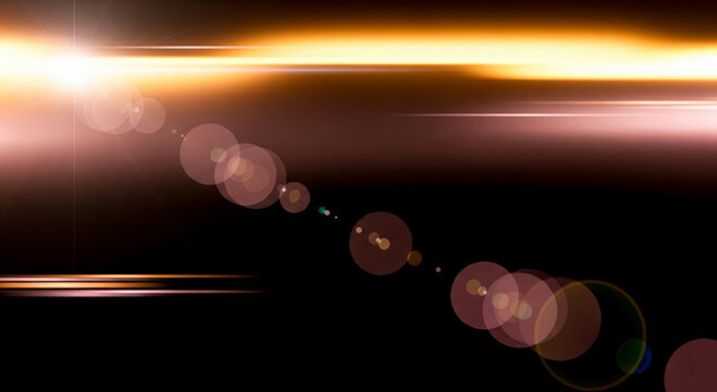 Optical lens flare effect with warm golden light and sun rays on black background. Abstract cinematic overlay for photo editing, film design or background texture