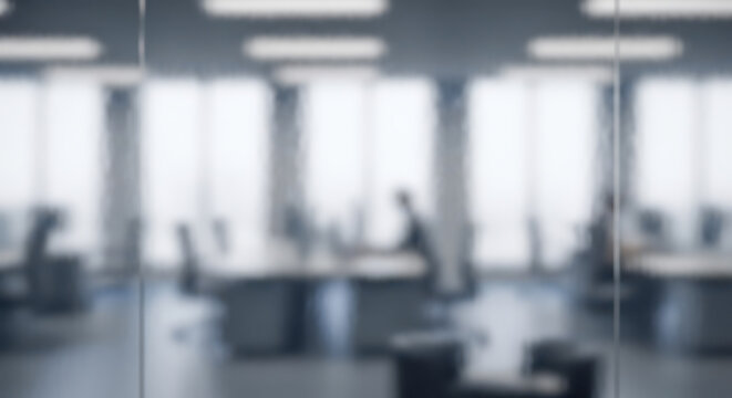 Blurred office background with modern open workspace and silhouettes of people working. Abstract corporate backdrop for business presentation or zoom call. Empty desk space for product placement