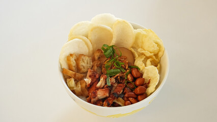 Bubur Ayam, chicken porridge with various toppings, shredded chicken, peanut, crackers and egg.