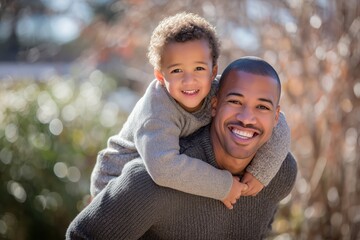 A father enjoying the outdoors while giving his son a piggyback ride