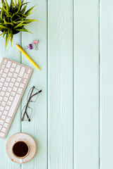 Home office workspace with computer keyboard and cup of coffee, on wwoden background, top view. Education online. Tabletop of freelancer.
