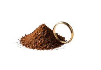 Golden wedding ring resting beside pile of rich coffee grounds, symbolizing morning ritual and luxury