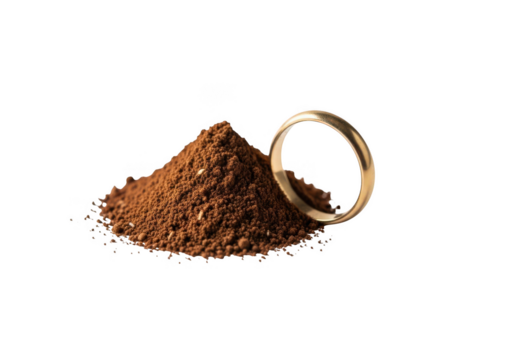 Golden wedding ring resting beside pile of rich coffee grounds, symbolizing morning ritual and luxury
