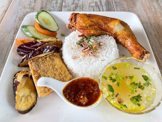 Display of Nasi Ayam Penyet menu on wooden table. Food and drink concept.