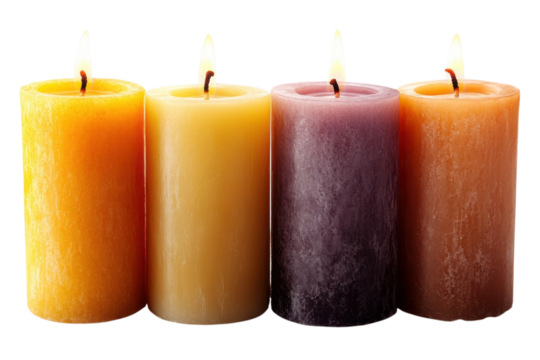 Four lit candles casting a warm glow in a dark room perfect for creating atmosphere and cozy