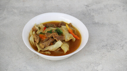 Tongseng Sapi or Beef Tongseng, Indonesian Traditional food made of beef with curry like soup and sweet soy sauce and various spices. white background