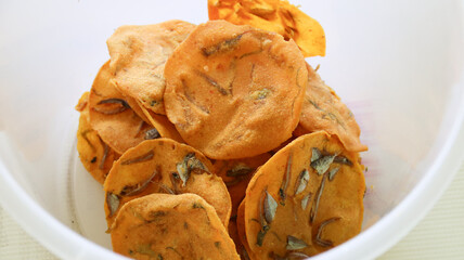 Rempeyek or anchovy peyek, fried savory Indonesian-Javanese crackers, made from wheat flour (usually rice flour), lime leaves and other ingredients, tied or coated with crunchy flour dough
